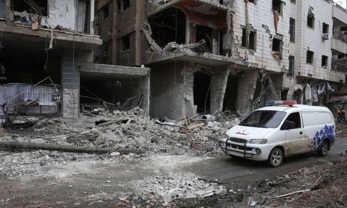 An ambulance is seen at the site of Syrian government bombardments in Hamouria, in the rebel-held besieged Eastern Ghouta region on the outskirts of the capital Damascus on February 22, 2018. (Abdulmonam Eassa/AFP/Getty Images)