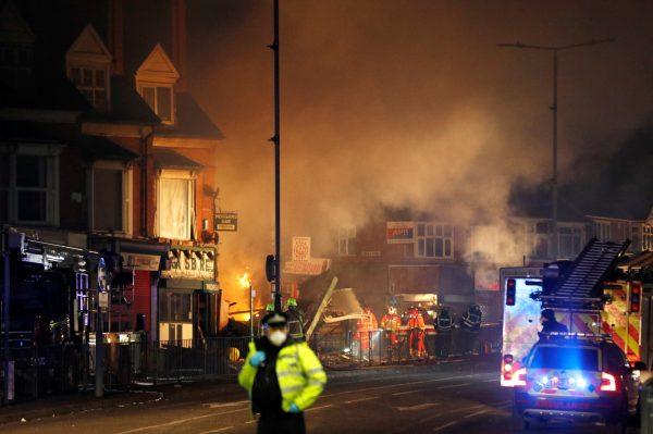 Members of the emergency services work at the site of an explosion which destroyed a convenience store and a home in Leicester, Britain, Feb. 25, 2018. (Reuters/Darren Staples)