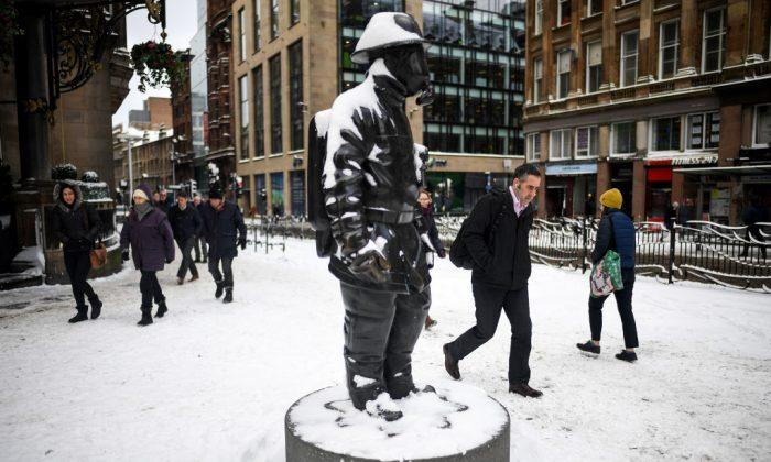 Members of the public make their way through the snow on Feb. 28, in Glasgow, Scotland. (Jeff J Mitchell/Getty Images)