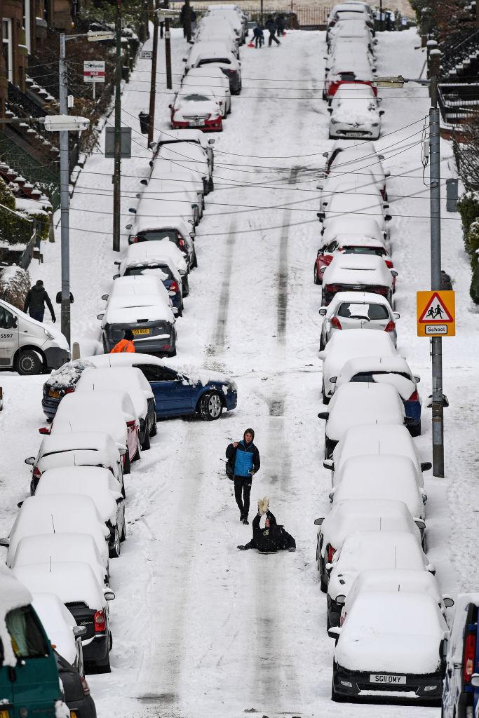Members of the public make their way through the snow in Gardner Street on Feb. 28, in Glasgow, Scotland. (Jeff J Mitchell/Getty Images)