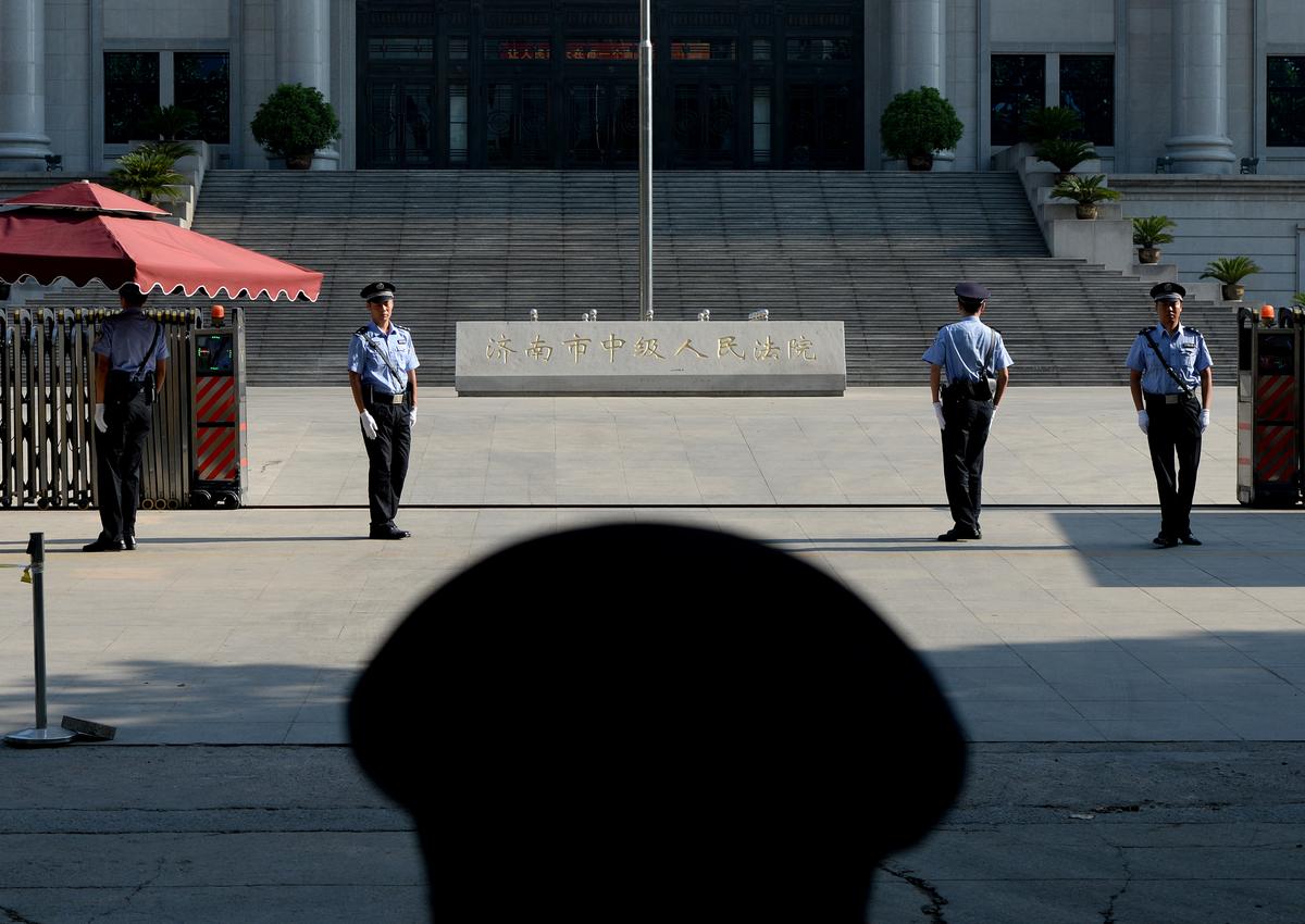 Police patrol outside the court trial of disgraced official Bo Xilai, who was sentenced for graft crimes, at the Intermediate People's Court in Jinan City, Shandong Province on Aug. 26, 2013. (Mark Ralston/AFP/Getty Images)