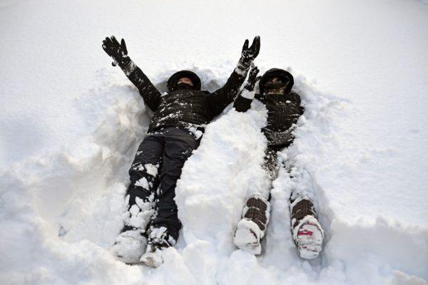 Two boys play in the snow on a housing estate on March 1, 2018 in Alexandria, Scotland. (Jeff J Mitchell/Getty Images)