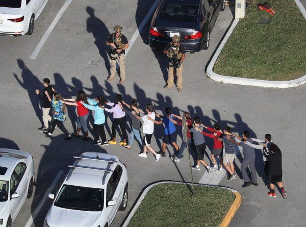 People are brought out of the Marjory Stoneman Douglas High School after a shooting at the school left 17 people dead on Feb. 14, 2018, in Parkland, Fla. (Joe Raedle/Getty Images)