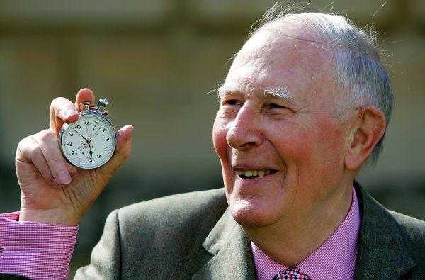 FILE PHOTO: Sir Roger Bannister, who ran the first sub-four-minute mile in 1954, holds the stop watch used by Harold Abrahams to time the race during 50th anniversary celebrations at Pembroke College, Oxford, May 6, 2004. (Reuters/David Bebber/File Photo)