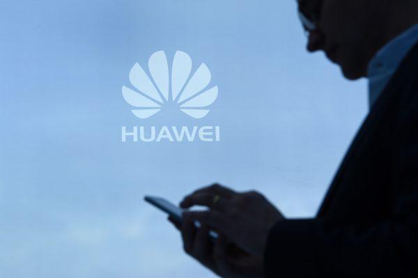 A visitor uses his mobile phone at the Huawei booth during the Mobile World Congress in Barcelona, Spain on February 28, 2017. (Lluis Gene/AFP/Getty Images)