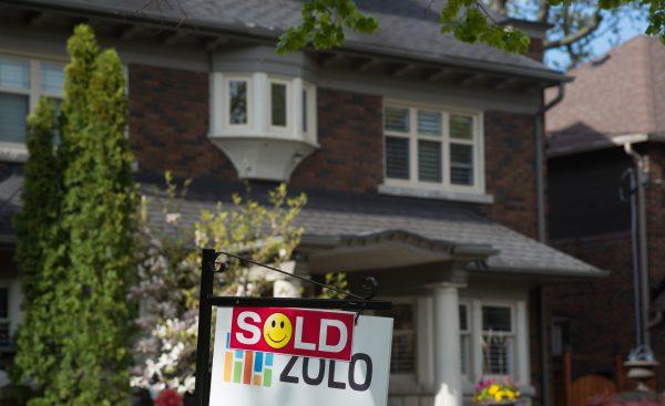 A sold sign is shown in front of west-end Toronto homes Sunday, May 14, 2017. THE CANADIAN PRESS/Graeme Roy