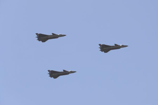 Chinese J-20 stealth fighter jets fly past during a military parade at the Zhurihe Training Base in China's northern Inner Mongolia region on July 30, 2017. (STR/AFP/Getty Images)