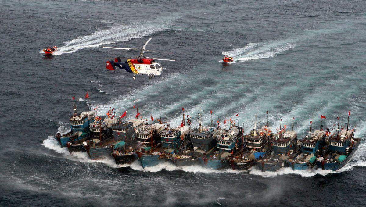 When confronted by South Korean Coast Guard helicopters and ships in the Yellow Sea in November 2011, this swarm of Chinese fishing boats banded together with ropes and bulled into the open sea— behind a shield of Chinese warships. (Dong-a Ilbo/AFP/Getty Images)