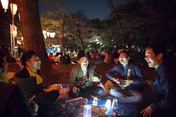 Hanami is an all-day affair, with picnicgoers feasting, drinking, and celebrating into the night. (Tomohiro Ohsumi/Getty Images)