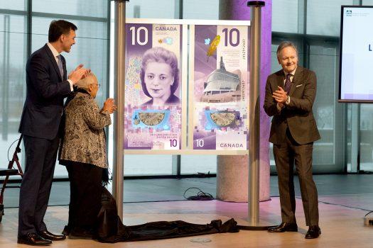 The new vertical Canadian $10 banknote featuring Viola Desmond was unveiled during a ceremony at the Halifax Public Library on March 8, 2018. (L to R) Finance Minister Bill Morneau, Wanda Robson, sister of Viola Desmond, and Bank of Canada Governor Stephen S. Poloz. (Bank of Canada)