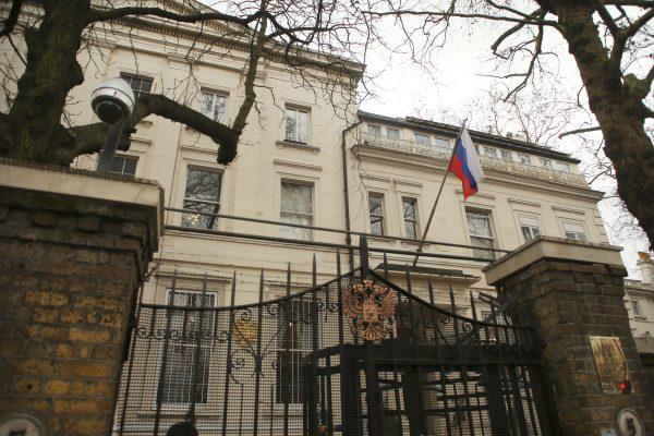 A flag and a security camera are seen at one of the entrances to Russia's embassy and consular section in London, March 13, 2018. (Reuters/Tom Jacobs)
