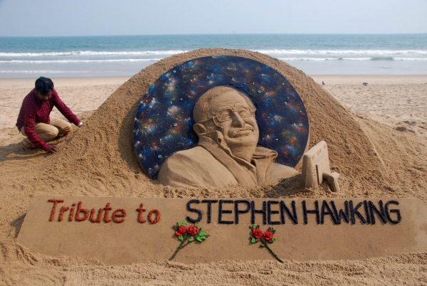 Sand artist Sudarsan Patnaik gives final touches to a sculpture in honour of British physicist and award-winning author Stephen Hawking at Puri beach, India, on March 14, 2018. (Asia Kumar/AFP/Getty Images)