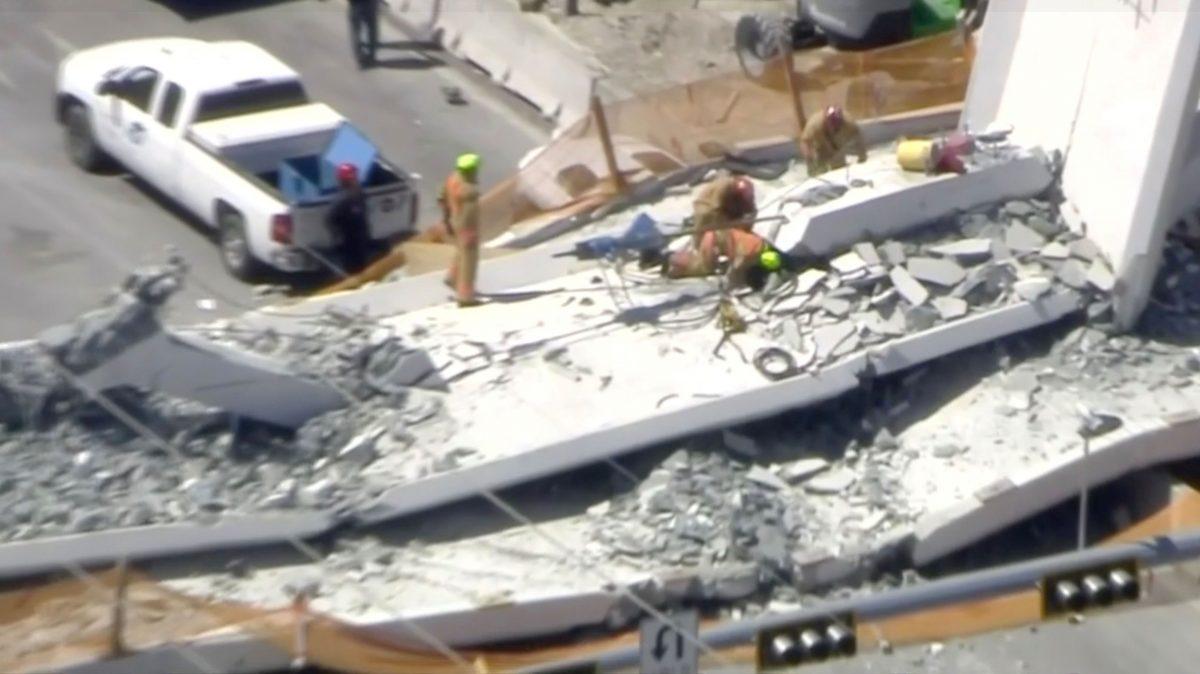 Emergency crews look for victims at the scene of a collapsed pedestrian bridge at Florida International University in Miami, Florida, U.S., March 15, 2018 in this still image from video. WTVJ-NBCMiami.com via REUTERS