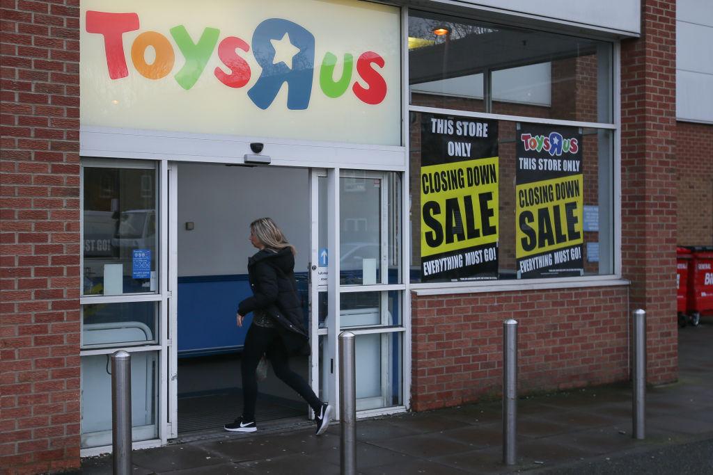 A customer walks inside a Toys 'R' Us store with 'closing down sale' signs in the windows in south London on February 9, 2018. (Daniel Leal-Olivas/AFP/Getty Images)