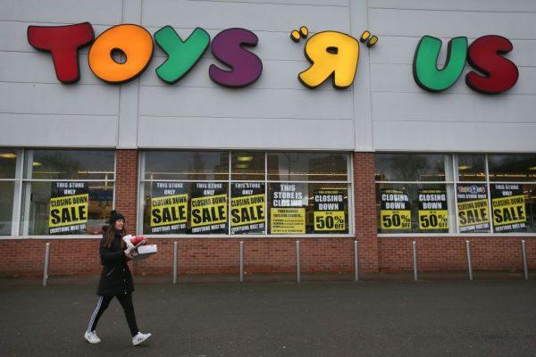 A customer walks out of a Toys r Us store with "closing down sale" signs in the windows in south London on Feb. 9, 2018. (Daniel Leal-Olivas/AFP/Getty Images)