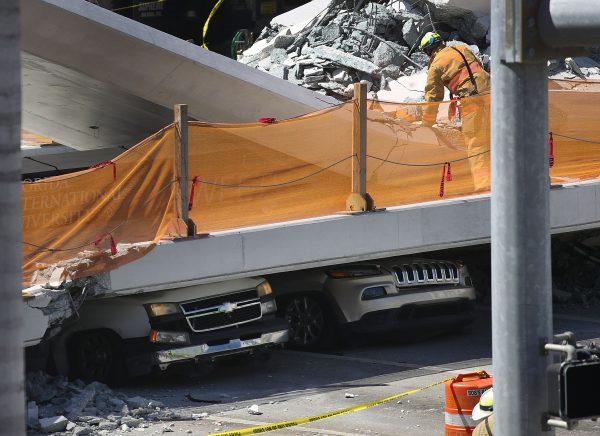 Vehicles are seen trapped under the collapsed pedestrian bridge in Miami, Fla., on March 15, 2018. (Joe Raedle/Getty Images)