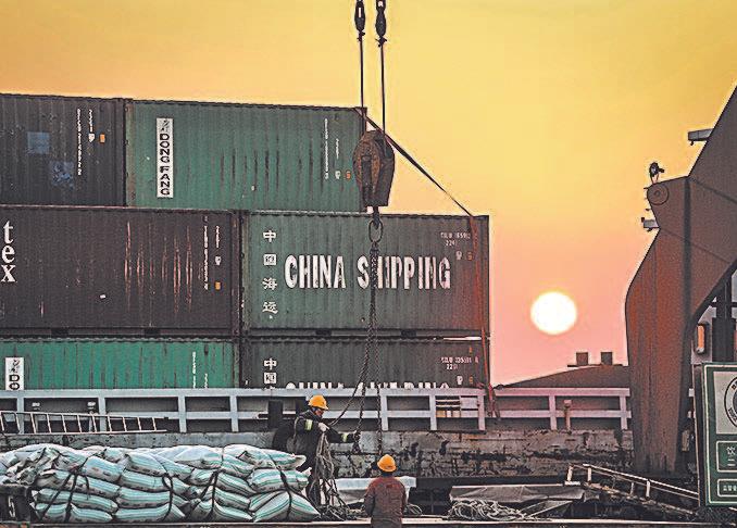 Workers load cargo on ships at a port in Nantong in China’s eastern Jiangsu Province on March 9. (AFP/GETTY IMAGES)