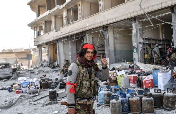 Turkish-backed Syrian Arab fighters loot shops after seizing control of Afrin on March 18, 2018. (Bulent Kilic/AFP/Getty Images)