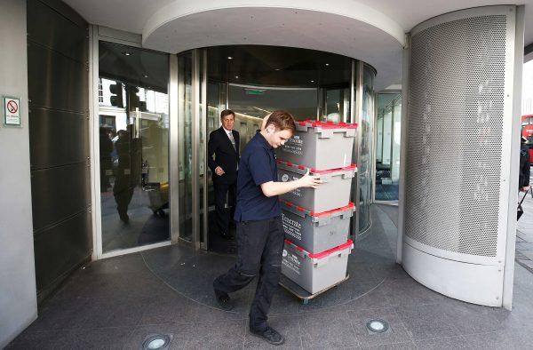 A man wheels storage crates from the building that houses the offices of Cambridge Analytica in central London, Britain, March 20, 2018. (Reuters/Henry Nicholls)