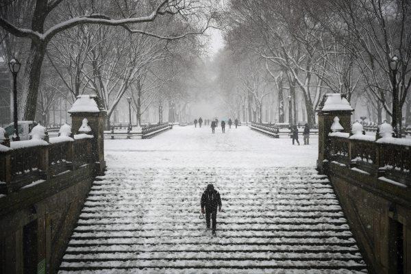 A man walks down steps toward the Bethesda Fountain and Terrace in Central Park during a snowstorm in New York City on March 21, 2018. (Drew Angerer/Getty Images)