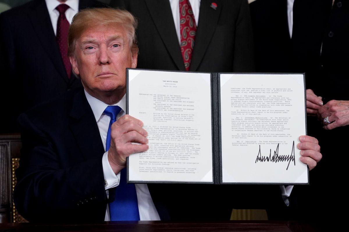 U.S. President Donald Trump holds his signed memorandum on intellectual property tariffs on high-tech goods from China at the White House in Washington, U.S., on March 22, 2018. (Jonathan Ernst/Reuters)