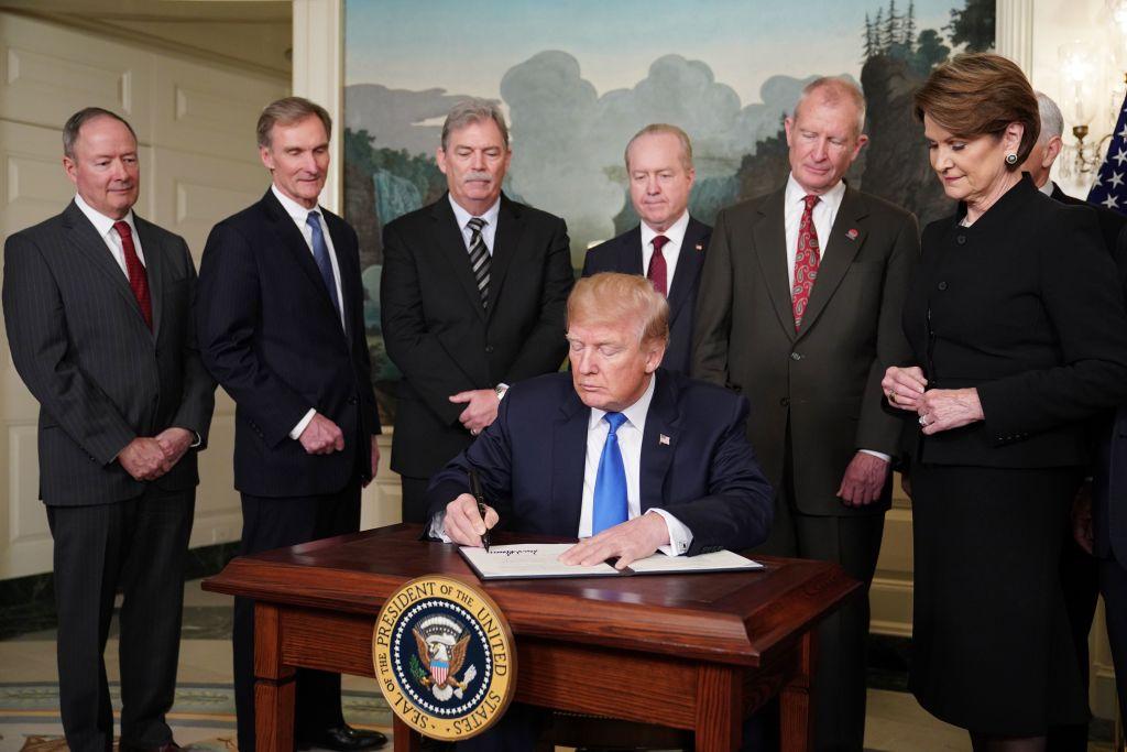 U.S. President Donald Trump signs trade sanctions against China in the Diplomatic Reception Room of the White House in Washington on March 22, 2018. (Mandel Ngan/AFP/Getty Images)