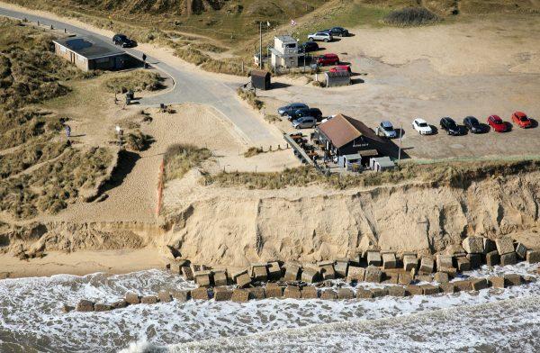 Homes in Hemsby, Norfolk, UK, hang over the cliff edge on March 21, 2018, after storms in the last few weeks. (Mike Page via SWNS)