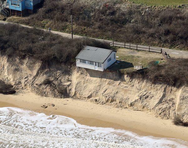 A home in Hemsby, Norfolk, UK, hangs over a cliff edge on March 21, 2018, after storms in the last few weeks. (Mike Page via SWNS)
