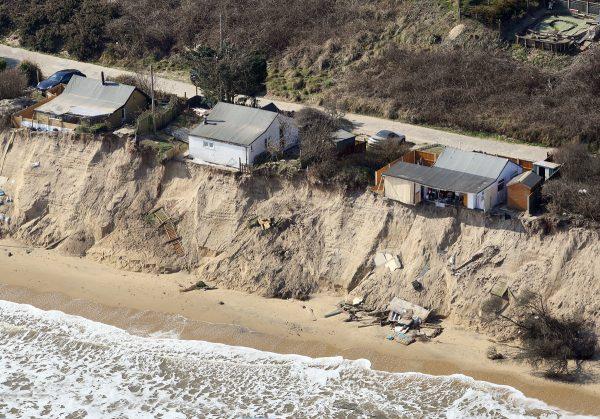 Homes in Hemsby, Norfolk, UK, hang over a cliff edge on March 21, 2018, after storms in the last few weeks. (Mike Page via SWNS)