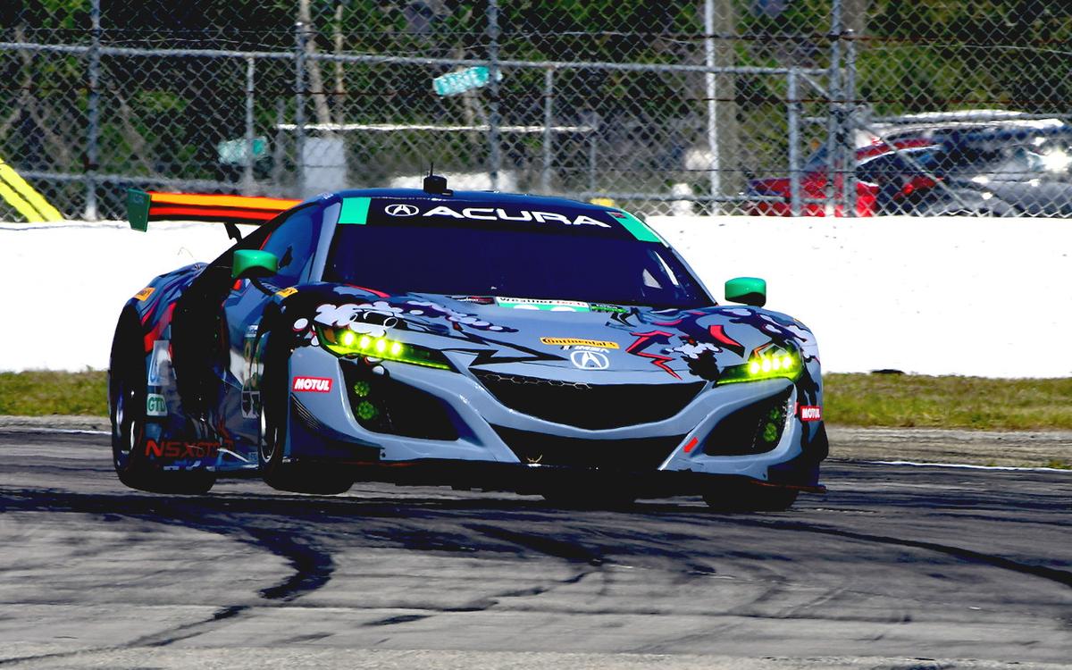 The #86 Acura NSX gets two wheels inthe air rounding Turn Ten. (Bill Kent/Epoch Times)