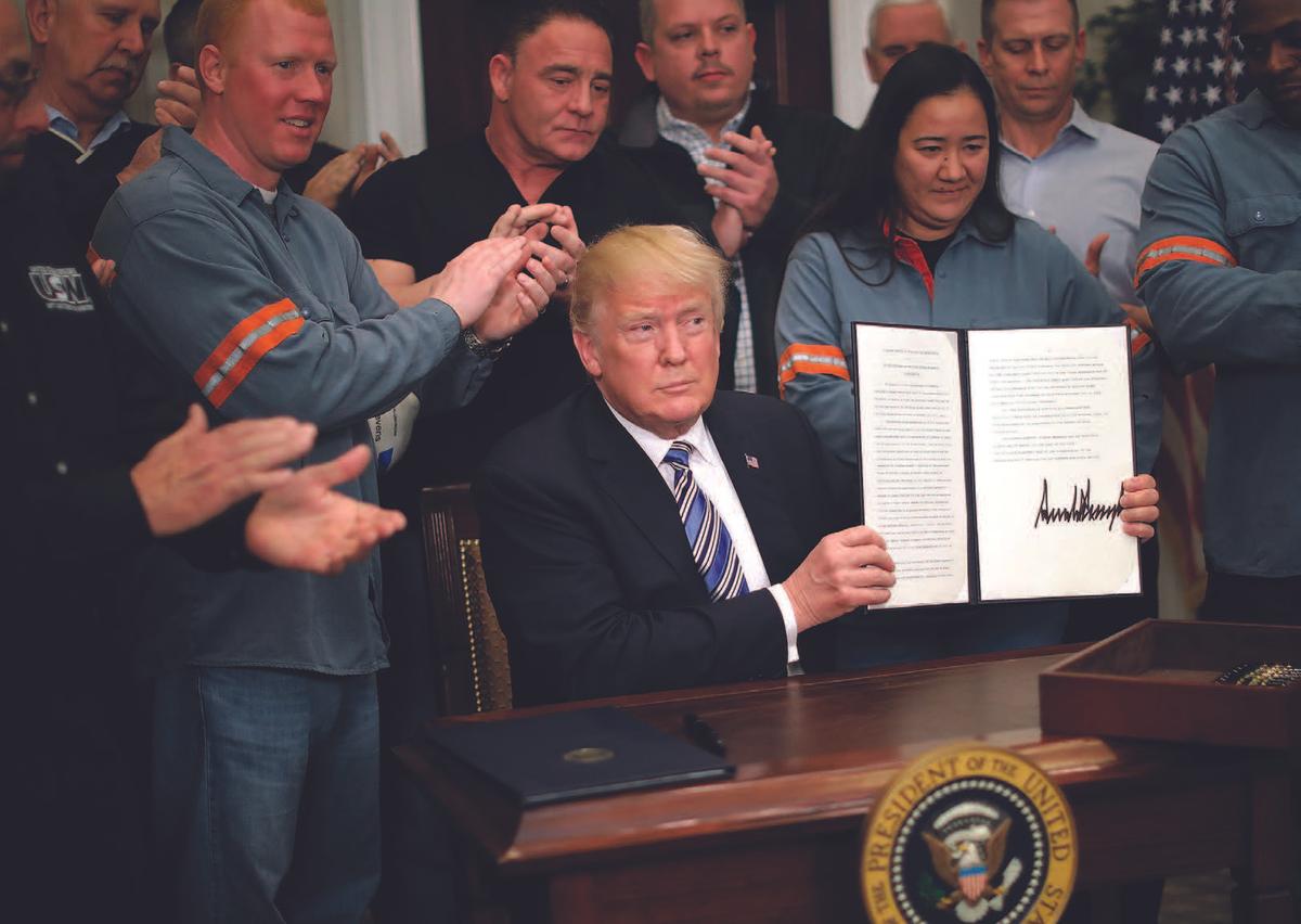 Surrounded by steel and aluminum workers, President Donald Trump signs a Section 232 proclamation on steel imports at the White House on March 8. Trump ordered a 25 percent tariff on imported steel and a 10 percent tariff on imported aluminum. (CHIP SOMODEVILLA/GETTY IMAGES)