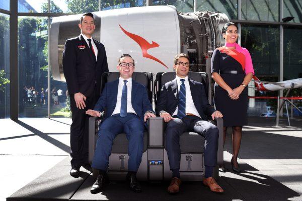 Qantas chief executive officer Alan Joyce (2nd L) and chief financial officer Tino La Spina (2nd R) test out the premium economy seat for the airline's new 787-9 Dreamliner after a press conference in Sydney on Feb. 23, 2017. (WILLIAM WEST/AFP/Getty Images)