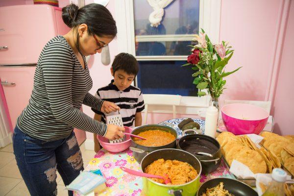 All the family members pitch in, from frying the tortillas to grating the queso fresco. (Benjamin Chasteen/The Epoch Times) . (Benjamin Chasteen/The Epoch Times)