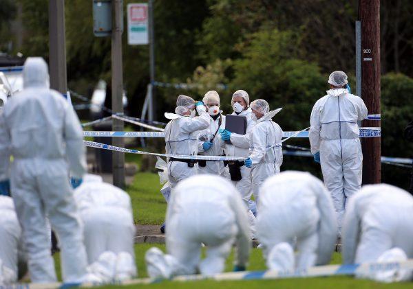 Police forensic officers conduct a fingertip search outside a house in Hattersley, Tameside where two female police officers were murdered on September 18, 2012 in Manchester, England. (Photo by Christopher Furlong/Getty Images)