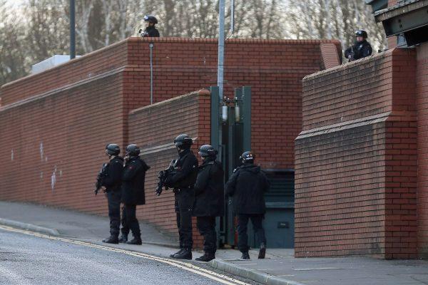 Armed police stand guard as Dale Cregan and nine other co-defendants arrive in an armed convoy to face charges of murder and attempted murder at Preston Crown on February 7, 2013 in Preston, Lancashire. (Photo by Christopher Furlong/Getty Images)