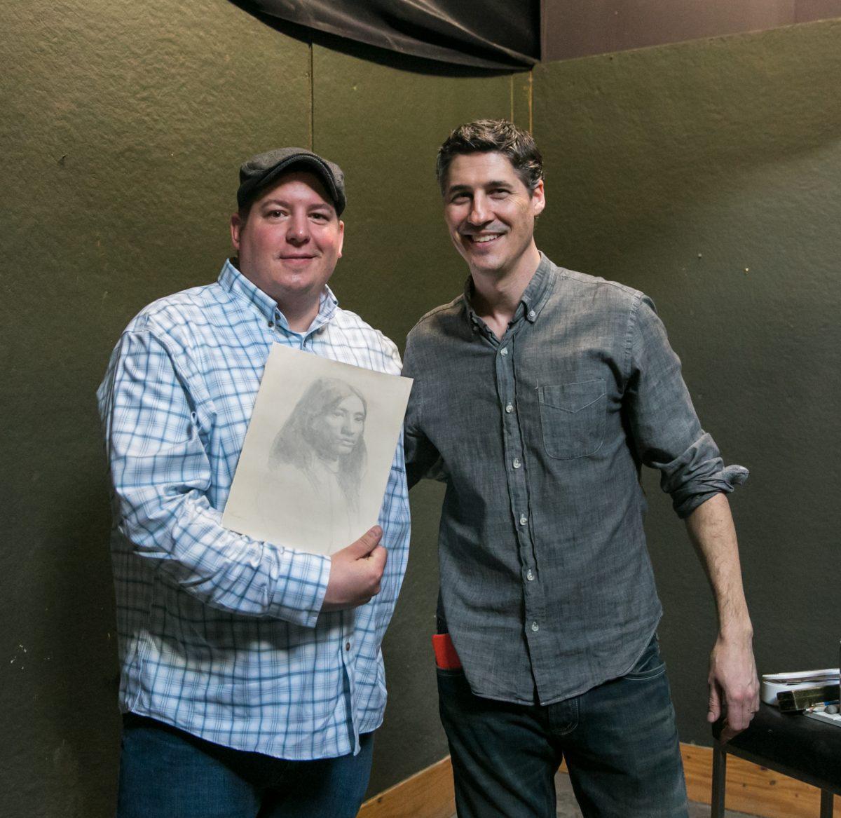 At the end of the workshop, Sean Witucki receives Edward Minoff's drawing as a gift, at Grand Central Atelier in Long Island City, Queens, N.Y., on March 9, 2018. (Milene Fernandez/The Epoch Times)