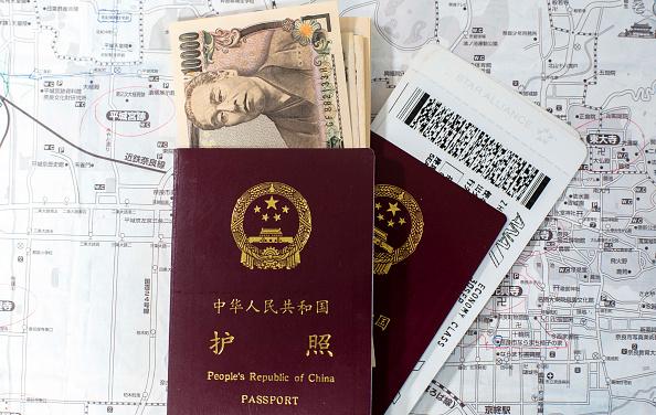 Chinese passport, Japanese yen, flight tickets. (Zhang Peng/Lightrocket via Getty Images)