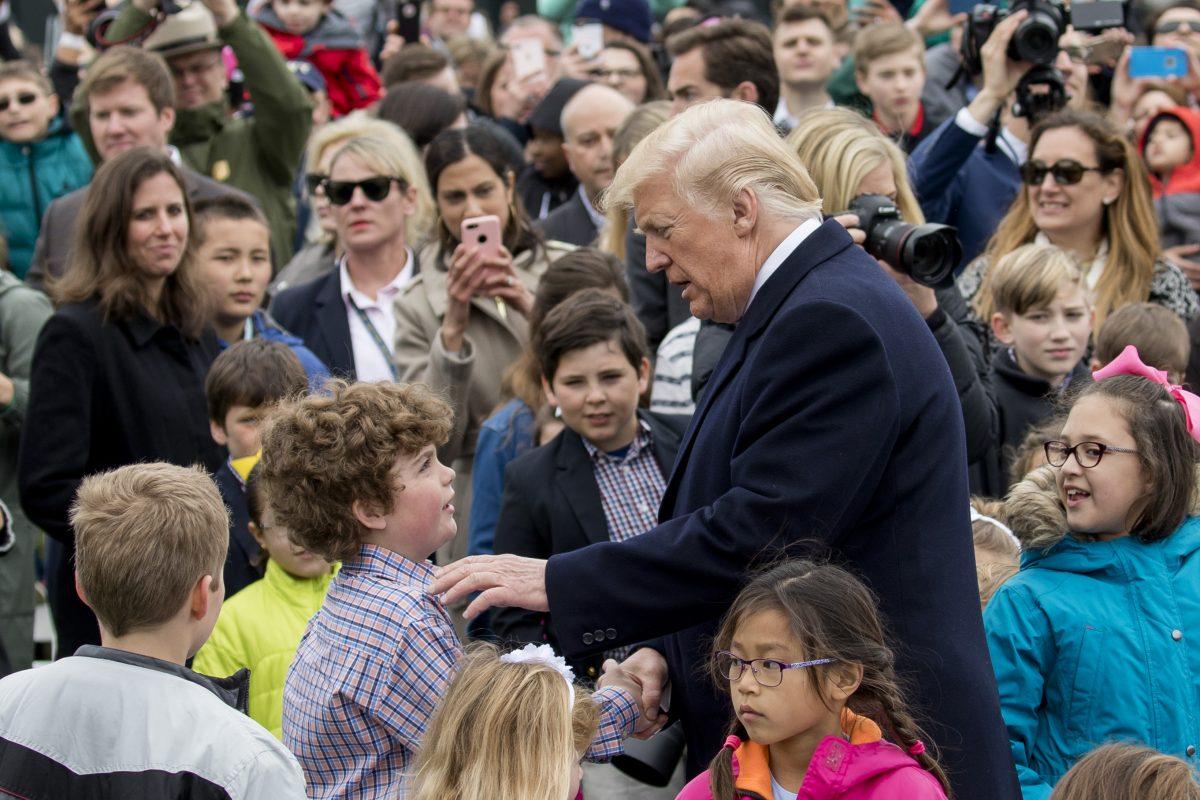 President Donald Trump greets children at the annual Easter Egg Roll on the South Lawn of the White House on April 2, 2018. (Samira Bouaou/The Epoch Times)