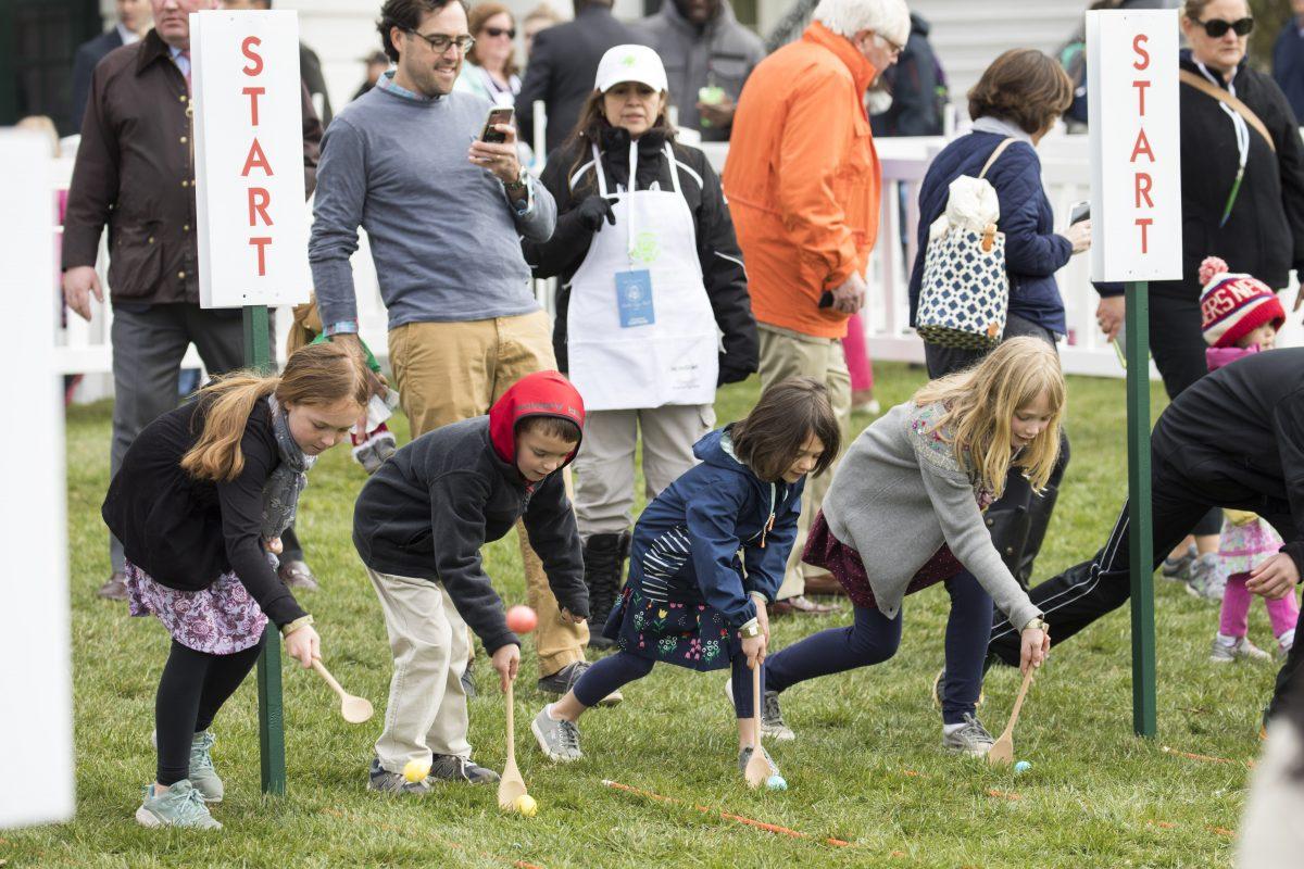 Children roll eggs at the annual Easter Egg Roll on the South Lawn of the White House on April 2, 2018. (Samira Bouaou/The Epoch Times)
