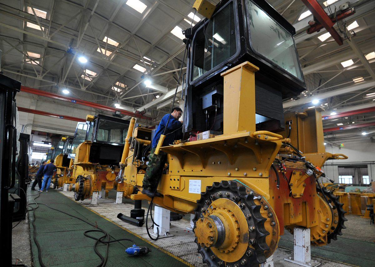 A Chinese employee working on a bulldozer at a factory in Zhangjiakou in China's northern Hebei Province on March 31, 2018. (AFP/Getty Images)