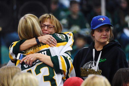 Mourners comfort each other during a vigil at the Elgar Petersen Arena, home of the Humboldt Broncos, to honour the victims of a fatal bus accident in Humboldt, Saskatchewan, Canada April 8, 2018. (Jonathan Hayward/Pool via Reuters)