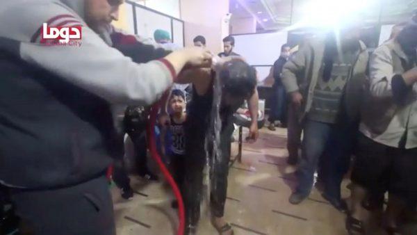 A man is washed following alleged chemical weapons attack, in what is said to be Douma, Syria in this still image from video obtained by Reuters on April 8, 2018. (White Helmets/Reuters TV via Reuters)