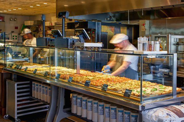 Roman fast food: Pizzas are lined up on shop counters, cut to order, and reheated, then taken to-go. (Neil Burger/Courtesy of Bonci USA)