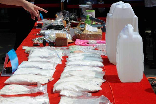 Chinese police display illicit drugs and various drug-making equipment seized during raids on drug processing labs in Nanning, southwest China's Guangxi Province, on May 17, 2012. (AFP/AFP/GettyImages)
