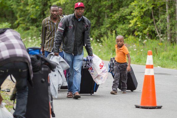 Asylum seekers arrive at the Canada-U.S. border near Champlain, N.Y., on Aug, 6, 2017.<br/>In recent days the number of people illegally crossing the border has grown into the hundreds. (Geoff Robins/AFP/Getty Images)