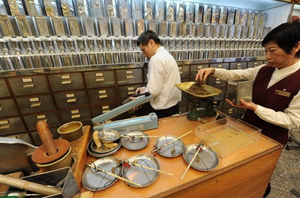 Workers at a traditional chinese medicine store prepare various dried items at a shop in Hong Kong on December 29, 2010. (Mike Clarke/AFP/Getty Images)