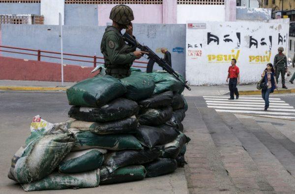 A soldier behind sandbags custody the Miraflores presidential house whilst Venezuelan President Nicolas Maduro and his vice-president Tareck El Aissami meet with workers of PDVSA state-owned oil company in Carcas January 31, 2017. (Juan Barreto/AFP/Getty Images)