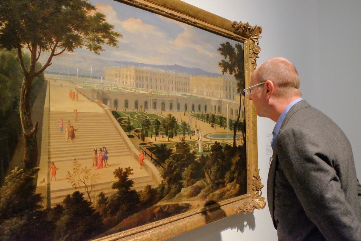 Prince Dimitri of Yugoslavia looks at "View of the Château de Versailles and the Orangerie," circa 1695, by Etienne Allegrain (1644–1736), in the "Visitors to Versailles (1682–1789)" exhibition at The Metropolitan Museum of Art in New York on April 9, 2018. (Hiroshi Nogami/The Epoch Times)