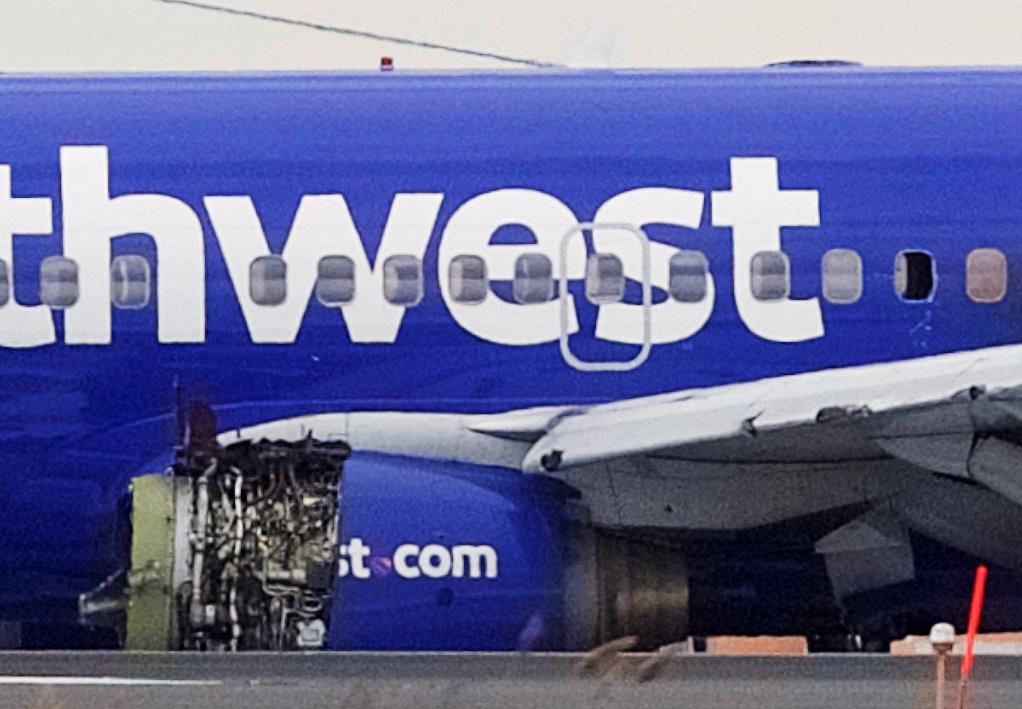 Emergency personnel monitor the damaged engine of Southwest Airlines Flight 1380, which diverted to the Philadelphia International Airport this morning after the airline crew reported damage to one of the aircraft's engines, on a runway in Philadelphia, Pennsylvania on April 17, 2018. (Reuters/Mark Makela)