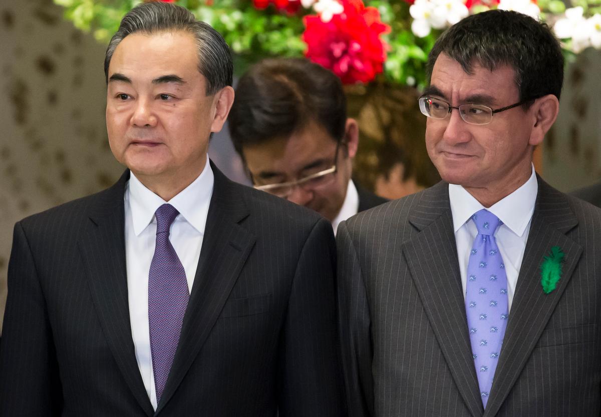 China's Foreign Minister Wang Yi (L) and Japan's Foreign Minister Taro Kono pose during a photo session ahead of a high-level Japan-China economic dialogue in Tokyo on April 16, 2018. (Tomohiro Ohsumi/AFP/Getty Images)